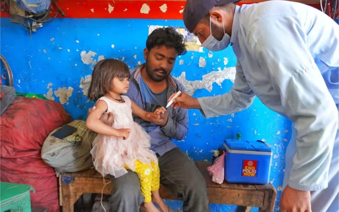 Vaccinator marking a vaccinated child in Pakistan