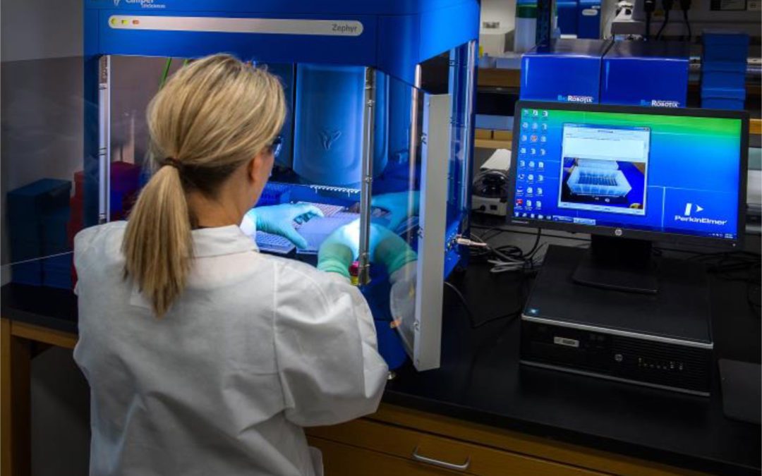 CDC scientist interacting with her Molecular Biology Workstation
